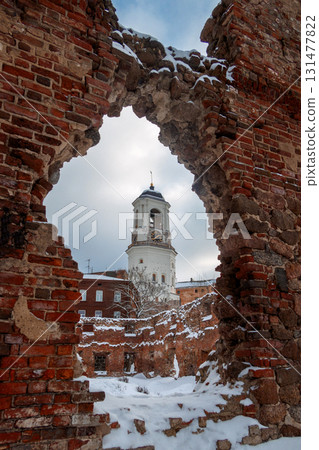 View of old Clock Tower through ruined brick wall. Belfry of Vyborg Cathedral, Vyborg, Russia. High quality photo 131477822