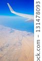 View from the window of plane on blue sky and earth with landscape of desert, sea and canals in Emirates. High quality photo 131478093