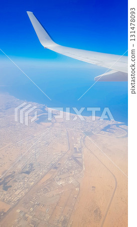 View from the window of plane on blue sky and earth with landscape of desert, sea and canals in Emirates. High quality photo View from the window of plane on blue sky and earth with landscape of desert, sea and canals in Emirates. High quality photo 131478093