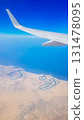 View from the window of plane on blue sky and earth with landscape of desert, sea and canals in Emirates. High quality photo 131478095