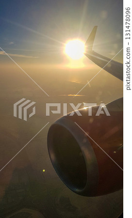 View from airplane porthole to beautiful sunset, blue sky and air clouds. High quality photoView from airplane porthole to beautiful sunset, blue sky and air clouds 131478096