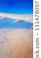 View from the window of plane on blue sky and earth with landscape of desert, sea and canals in Emirates. High quality photo 131478097