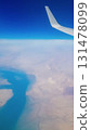 View from the window of plane on blue sky and earth with landscape of desert, sea and canals in Emirates. High quality photo 131478099