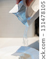 Woman's hand pours flour from package into plate for cooking. High quality photo 131478105