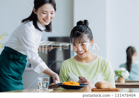 A young woman who eats at a cafe 131478404