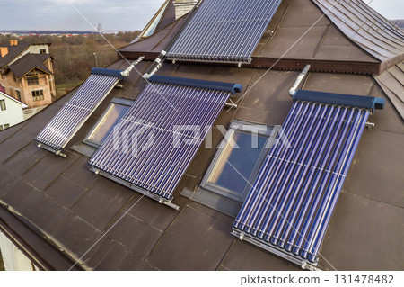 Solar water heating system on house roof. Hot water boiler, alternative ecological sun energy generator. 131478482