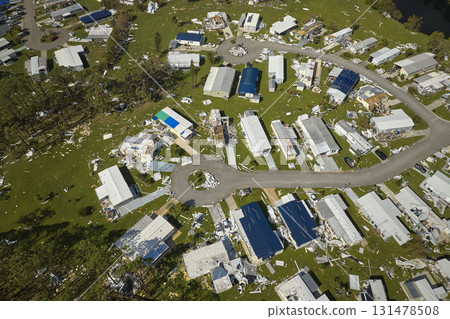 Severely damaged by hurricane Ian houses in Florida mobile home residential area. Consequences of natural disaster 131478508