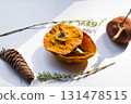 Dried pumpkin - container with a lid and a dried mandarin with a leaf, horsetail, and a spruce cone on a white background. Still life. 131478515