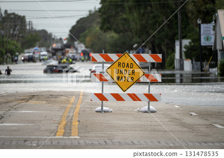 Road under water warning sign. City street closed because of flooding danger blocking driving of cars Road under water warning sign. City street closed because of flooding danger blocking driving of cars 131478535