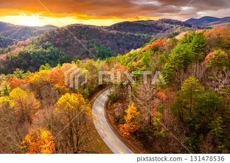 Road trip in fall season through Appalachian forest in Tennessee. Car driving on a winding road under colorful autumn canopy Road trip in fall season through Appalachian forest in Tennessee. Car driving on a winding road under colorful autumn canopy 131478536