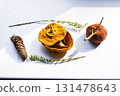 Dried pumpkin - container with a lid and a dried mandarin with a leaf, horsetail, and a spruce cone on a white background. Still life. 131478643