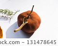 Dried pumpkin - container with a lid and a dried mandarin with a leaf, horsetail, and a spruce cone on a white background. Still life. 131478645
