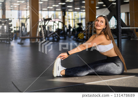 Athletic fitness woman stretching body at gym enjoy physical exercise activity Athletic fitness woman stretching body at gym enjoy physical exercise activity 131478689
