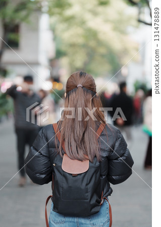 woman traveler visiting in Shanghai, China. Female Tourist with backpack sightseeing in Xintiandi. landmark and popular for tourism attractions in Shanghai. Travel and vacation concept woman traveler visiting in Shanghai, China. Female Tourist with backpack sightseeing in Xintiandi. landmark and popular for tourism attractions in Shanghai. Travel and vacation concept 131478889
