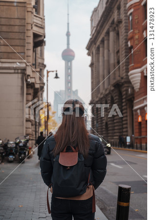 woman traveler visiting in Shanghai, China. Happy Female Tourist sightseeing Oriental Pearl Tower view in The Rock Bund of Shanghai. landmark and popular for tourism attractions. Travel and Vacation woman traveler visiting in Shanghai, China. Happy Female Tourist sightseeing Oriental Pearl Tower view in The Rock Bund of Shanghai. landmark and popular for tourism attractions. Travel and Vacation 131478923
