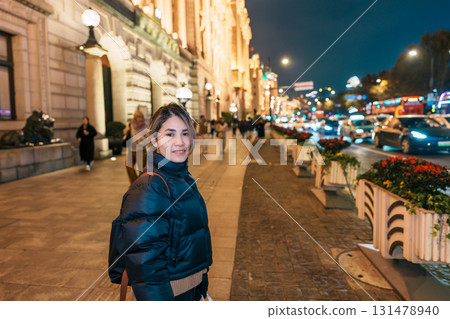 woman traveler visiting in Shanghai, China. Happy Female Tourist sightseeing Shanghai view in The Bund of Shanghai at night. landmark and popular for tourism attractions. Travel and Vacation concept woman traveler visiting in Shanghai, China. Happy Female Tourist sightseeing Shanghai view in The Bund of Shanghai at night. landmark and popular for tourism attractions. Travel and Vacation concept 131478940