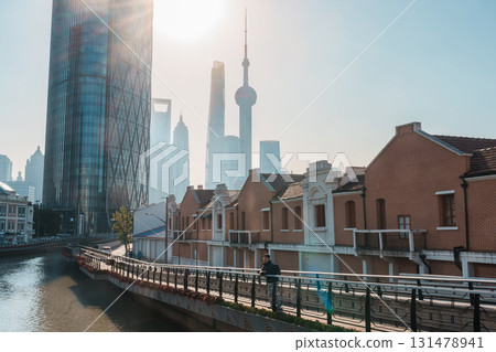 man traveler visiting in Shanghai, China. male Tourist with backpack sightseeing Shanghai view of Lujiazui in Hongkou Gang canal of Shanghai. landmark and popular for tourism attraction 131478941
