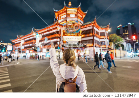 woman traveler visiting in Shanghai, China. Happy Female Tourist sightseeing and shopping in Yuyuan Old Street market at night. landmark and popular for tourism attractions. Travel and Vacation woman traveler visiting in Shanghai, China. Happy Female Tourist sightseeing and shopping in Yuyuan Old Street market at night. landmark and popular for tourism attractions. Travel and Vacation 131478947