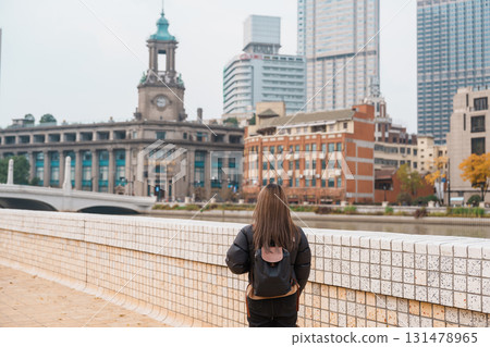 woman traveler visiting in Shanghai, China. Happy Female Tourist sightseeing Shanghai view. landmark and popular for tourism attractions. Travel and vacation concept woman traveler visiting in Shanghai, China. Happy Female Tourist sightseeing Shanghai view. landmark and popular for tourism attractions. Travel and vacation concept 131478965