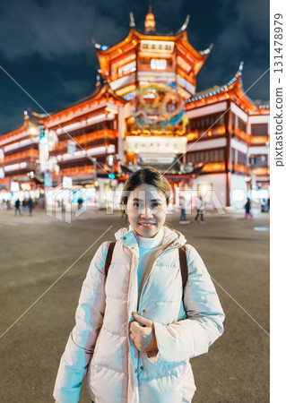 woman traveler visiting in Shanghai, China. Happy Female Tourist sightseeing and shopping in Yuyuan Old Street market at night. landmark and popular for tourism attractions. Travel and Vacation woman traveler visiting in Shanghai, China. Happy Female Tourist sightseeing and shopping in Yuyuan Old Street market at night. landmark and popular for tourism attractions. Travel and Vacation 131478979