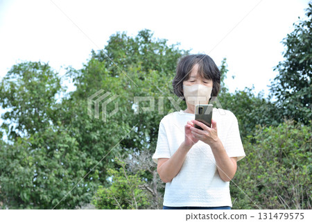 A woman operating a mobile phone 131479575