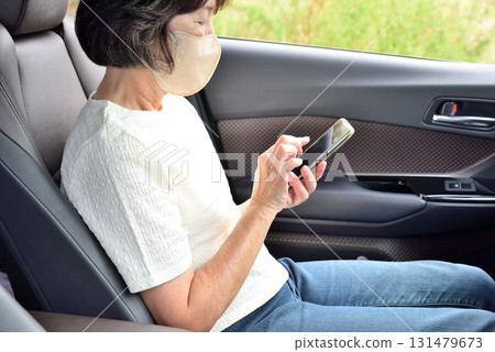 A woman operating a mobile phone 131479673