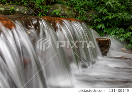 A silky waterfall in a mountain stream 131480149