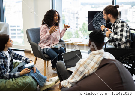 Diverse group of young professionals collaborating on artificial intelligence project in modern workspace. Analysis includes brainstorming and discussion. 131481036