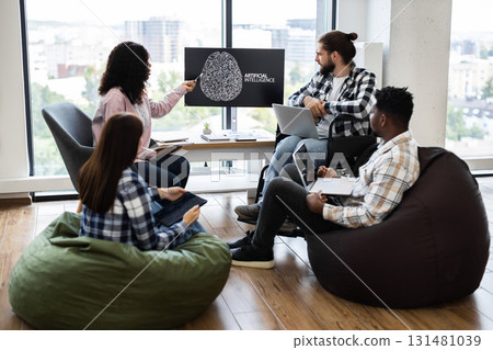 Diverse group of colleagues collaborating on artificial intelligence project in workspace. Individuals utilize technology for creative problem solving and effective teamwork in relaxed environment. Diverse group of colleagues collaborating on artificial intelligence project in workspace. Individuals utilize technology for creative problem solving and effective teamwork in relaxed environment. 131481039