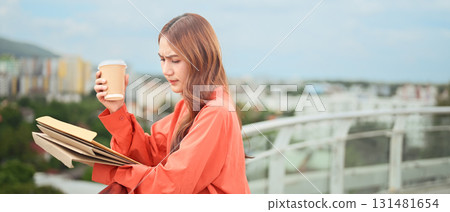 Businesswoman looking worried while reviewing paperwork with coffee in hand Businesswoman looking worried while reviewing paperwork with coffee in hand 131481654