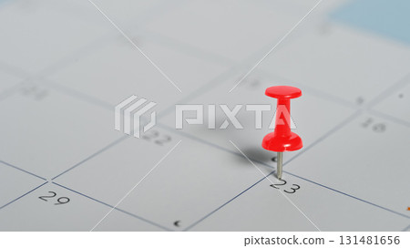 Red push pin marking the 23rd on a calendar, concept of appointment and important date planning Red push pin marking the 23rd on a calendar, concept of appointment and important date planning 131481656