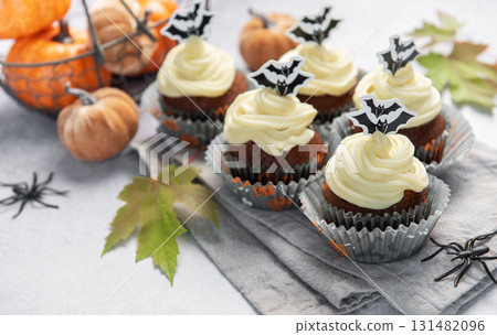 Halloween cupcakes with bat decoration and small pumpkins Halloween cupcakes with bat decoration and small pumpkins 131482096