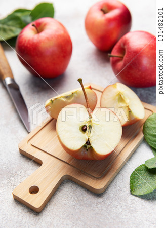 Red apples slicing on cutting board ready for healthy snack 131482101