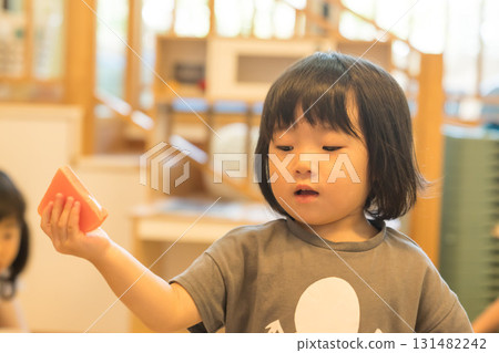 Toddler girl playing with toys 131482242