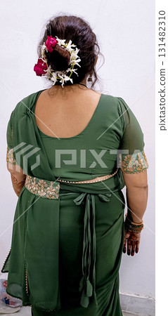 Traditional Green Saree with Floral Bun Hairstyle Traditional Green Saree with Floral Bun Hairstyle 131482310