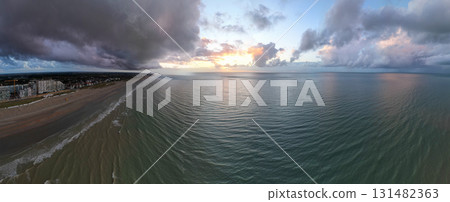 The Serene Sunset Over a Calm Beach with Beautiful Clouds Creates an Idyllic Scene 131482363