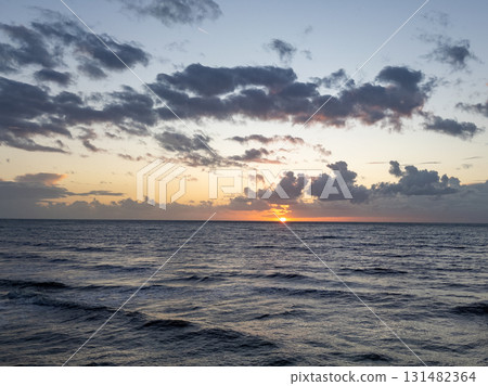 A Serene Sunset Gracefully Stretching Over Calm Ocean Waves, Capturing Natures Beauty 131482364