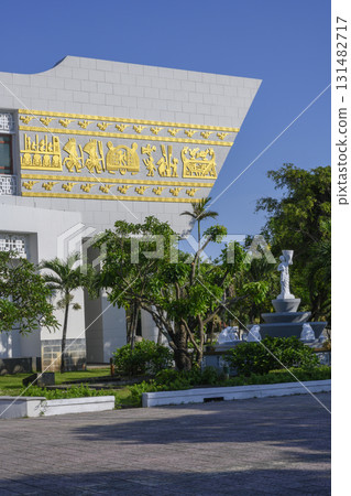 A fragment of the Bao Tang museum building with a golden bas-relief and a park with sculptures A fragment of the Bao Tang museum building with a golden bas-relief and a park with sculptures 131482717