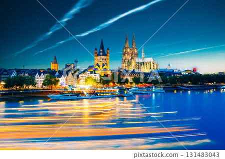 Great St. Martin Church And Dom In Cologne At Evening With Reflection In River Rhine, Germany Great St. Martin Church And Dom In Cologne At Evening With Reflection In River Rhine, Germany 131483043