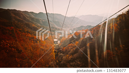 Aerial View of Cable Cars Over Autumnal Mountain Range 131483077