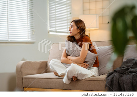 Sad and depressed young asian female sitting on the floor in the room, sad mood, feel tired, lonely and unhappy concept. Selective focus. Sad and depressed young asian female sitting on the floor in the room, sad mood, feel tired, lonely and unhappy concept. Selective focus. 131483156