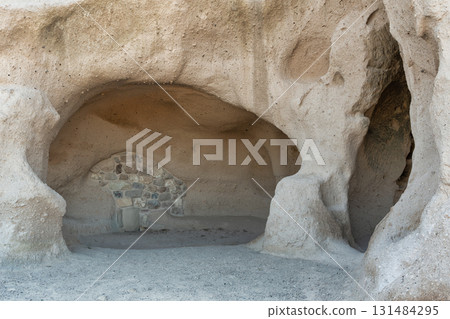 Historic Rock Cave Dwelling with Stone Wall, Uchisar Castle, Cappadocia, Turkey. 131484295