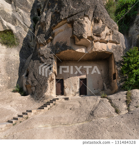 Cappadocia rock-cut cave church entrance with fresco and steps, Goreme Open-Air Museum, Turkey Cappadocia rock-cut cave church entrance with fresco and steps, Goreme Open-Air Museum, Turkey 131484328
