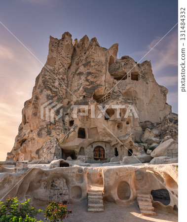 Uchisar Castle, a stunning rock-cut fortress and cave village in Cappadocia, Turkey, at sunset Uchisar Castle, a stunning rock-cut fortress and cave village in Cappadocia, Turkey, at sunset 131484332