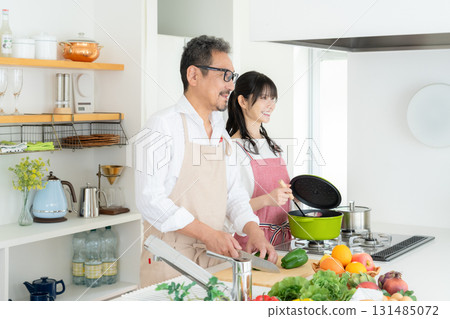 Middle-aged couple cooking in the kitchen 131485072
