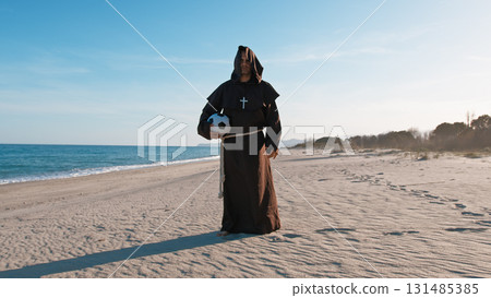 A Monk Dribbling Barefoot With The Ball At The Beach 131485385