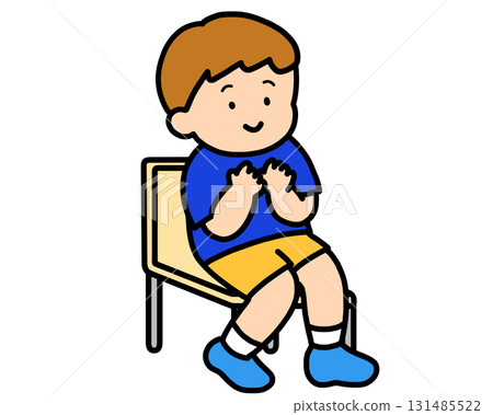 Boy sitting on a chair clapping 131485522