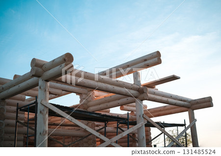 Construction of a house from rounded logs Construction of a house from rounded logs 131485524