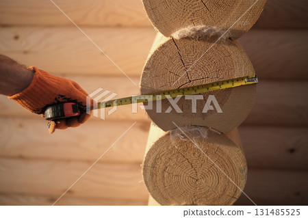 Construction of a house from rounded logs 131485525