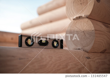 Construction of a house from rounded logs Construction of a house from rounded logs 131485547